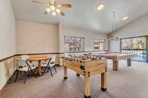 Recreation room with light carpet, vaulted ceiling, a ceiling fan, and billiards