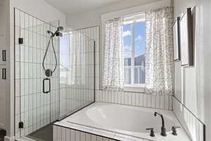 Bathroom with a bath and a stall shower