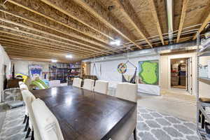 Dining space featuring unfinished concrete flooring