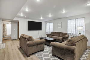 Living room featuring light wood-type flooring and recessed lighting