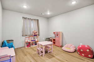 Game room featuring light wood finished floors and recessed lighting