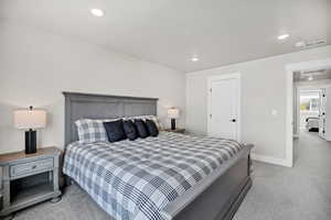 Bedroom featuring light carpet and recessed lighting