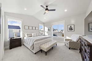 Bedroom with vaulted ceiling, light colored carpet, multiple windows, recessed lighting, and ceiling fan