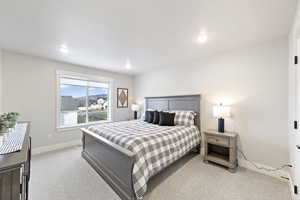 Bedroom featuring light colored carpet and recessed lighting