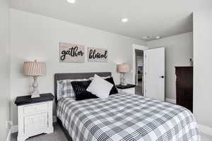 Carpeted bedroom featuring baseboards