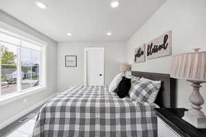 Carpeted bedroom with baseboards and recessed lighting