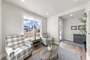 Sitting room with wood finished floors and recessed lighting