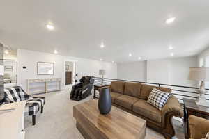 Living room with light carpet and recessed lighting