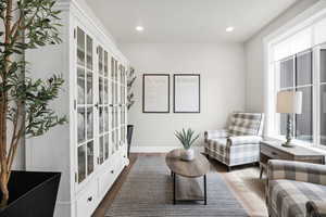 Living area featuring recessed lighting and dark wood-style floors