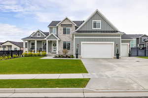 View of front of home featuring board and batten siding, a porch, driveway, and a standing seam roof