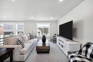 Living room featuring light colored carpet and baseboards