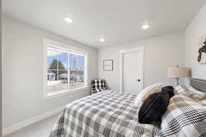Carpeted bedroom featuring baseboards and recessed lighting