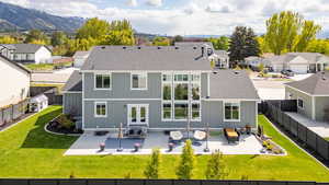 Rear view of house with a patio area, a residential view, roof with shingles, and a fenced backyard