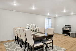 Dining area featuring light wood-style floors and recessed lighting