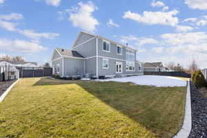 Rear view of property with a fenced backyard, board and batten siding, a patio area, and entry steps