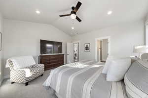 Bedroom with carpet flooring, vaulted ceiling, a ceiling fan, and recessed lighting