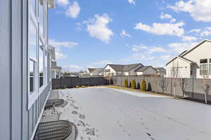 Fenced backyard with a residential view