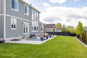 Fenced backyard with entry steps, a patio area, and an outdoor living space