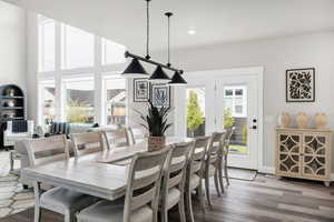Dining room featuring wood finished floors, recessed lighting, and a high ceiling