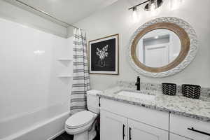 Full bathroom featuring vanity and shower / bath combo with shower curtain