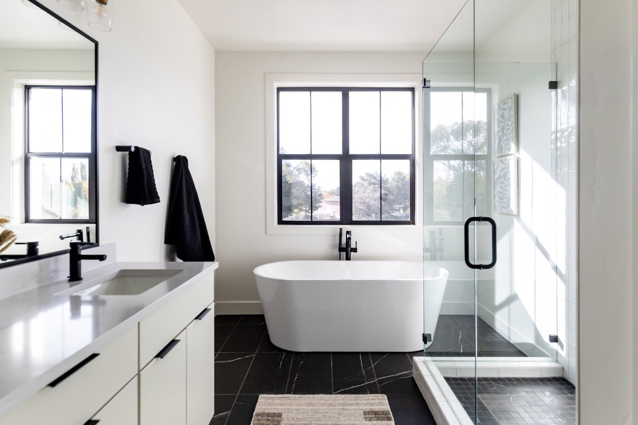 Full bathroom featuring vanity, a shower stall, a soaking tub, and healthy amount of natural light