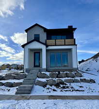 View of front of home with brick siding and board and batten siding