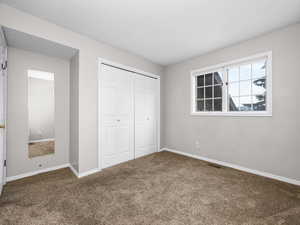 Unfurnished bedroom with carpet floors and a closet