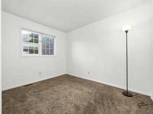 Spare room featuring carpet flooring