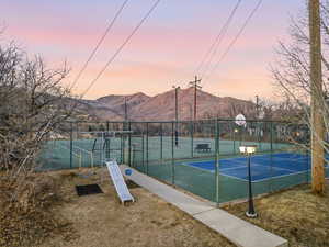 View of tennis court featuring a mountain view