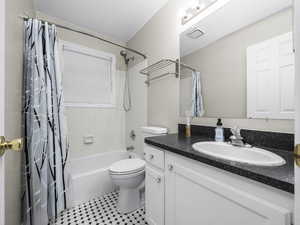 Bathroom with shower / bath combo with shower curtain and vanity
