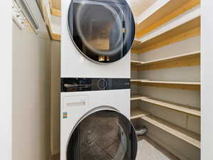 Laundry room with stacked washer and dryer