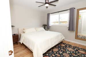 Bedroom with light wood-style flooring and a ceiling fan