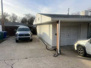 View of home's exterior with brick siding and roof with shingles