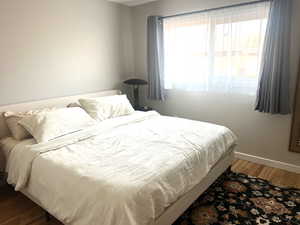 Bedroom with light wood-style floors and baseboards