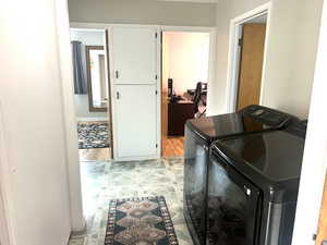 Laundry room featuring separate washer and dryer and light floors