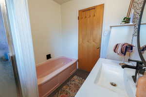 Bathroom with a bath and vanity