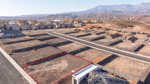 Aerial perspective of suburban area with property parcel outlined and mountains