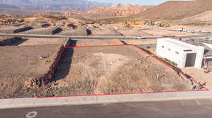 Aerial view of property's location featuring a mountainous background and property parcel outlined