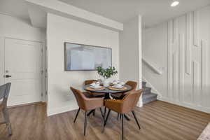 Dining room with wood finished floors and recessed lighting