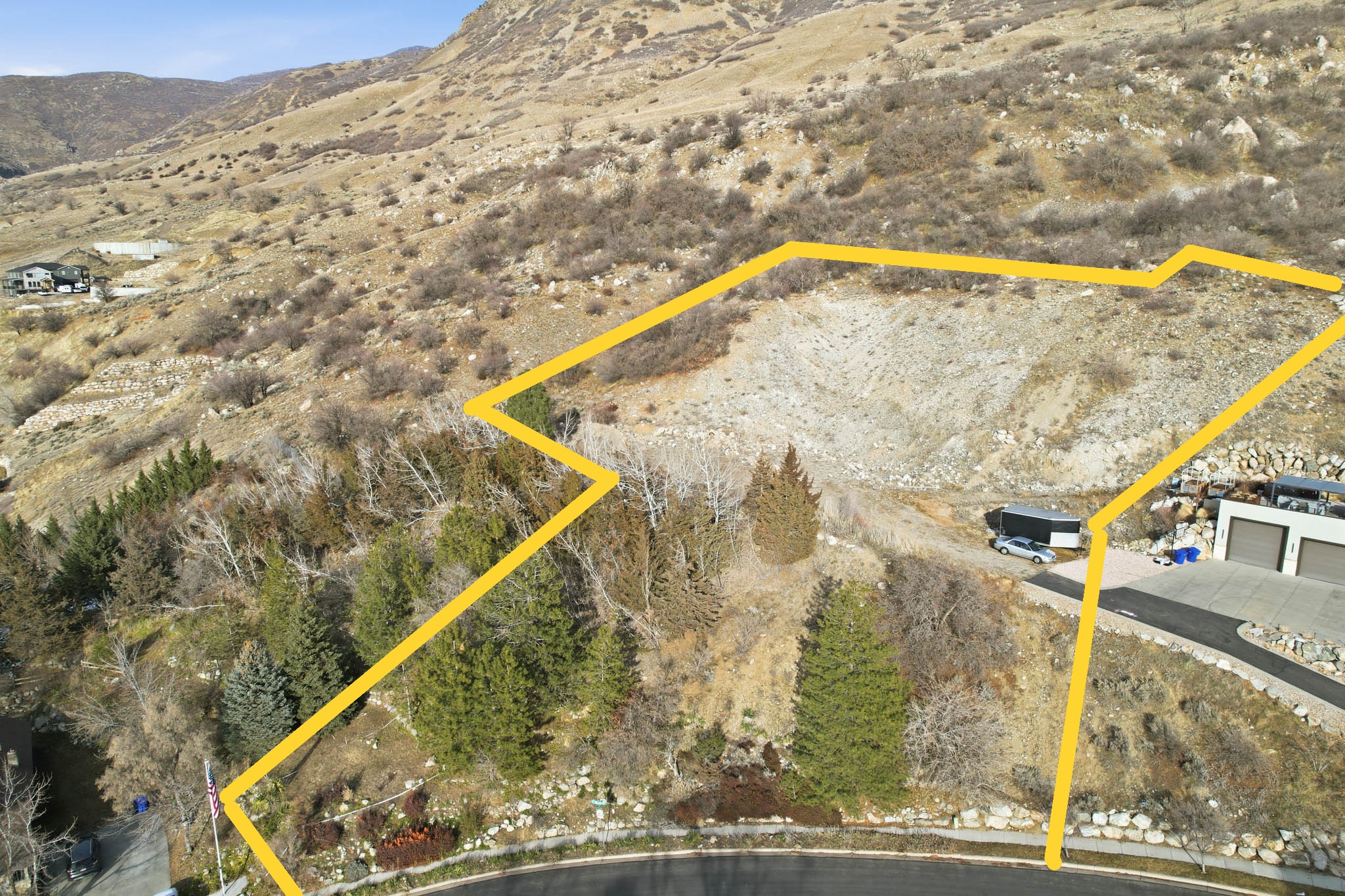 View of rural area featuring a mountain backdrop and property parcel outlined