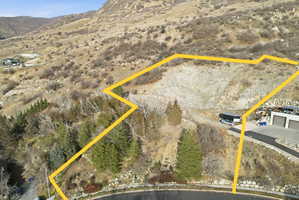 View of rural area featuring a mountain backdrop and property parcel outlined