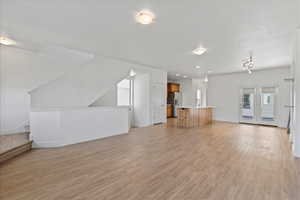 Unfurnished living room with light wood-type flooring and recessed lighting