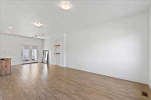 Unfurnished living room with light wood-type flooring and recessed lighting