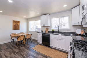 Kitchen featuring white cabinetry, dishwasher, range with gas stovetop, and recessed lighting