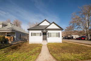 Bungalow-style house featuring roof with shingles