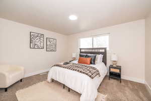Carpeted bedroom with baseboards