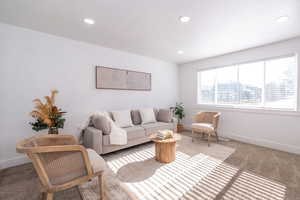 Carpeted living room with baseboards and recessed lighting