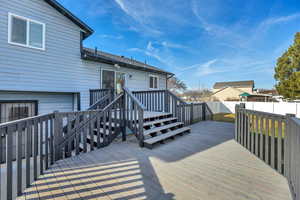 Wooden deck featuring a fenced backyard and stairway