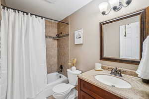 Full bathroom featuring shower / bath combo with shower curtain and vanity