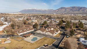Aerial view of property's location with a mountainous background and nearby suburban area